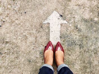 Low section of woman standing on street