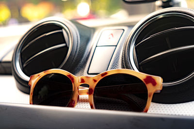 Put the glasses on the console car and sun shines down, making the outside look beautiful bokeh.