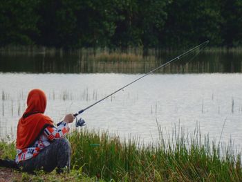 Woman fishing in lake