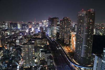 Aerial view of illuminated buildings in city at night