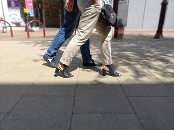 Low section of man walking on footpath