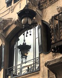 Low angle view of illuminated street light on building