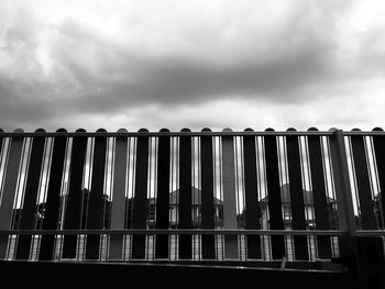 Low angle view of fence against sky
