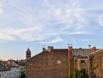 Houses against cloudy sky