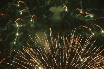 Low angle view of firework display at night