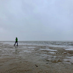 Man on beach against sky