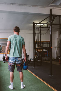 Rear view of man standing in corridor