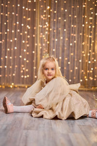 Portrait of young woman sitting at home