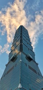 Low angle view of building against cloudy sky