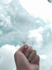 Midsection of person holding hands against sky