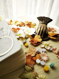 Portrait of a messy table filled with tiny flowers and leafs for scrapbook material