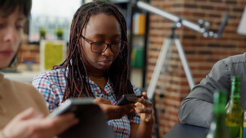 Business colleagues using phone in office