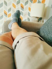 Low section of person relaxing on sofa