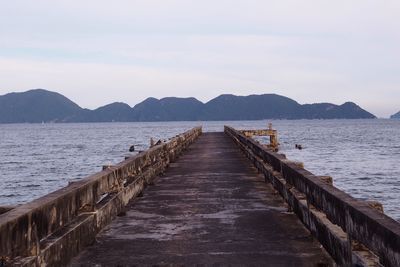 Pier over sea against sky