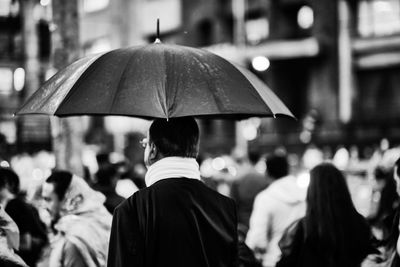 Rear view of people walking in city