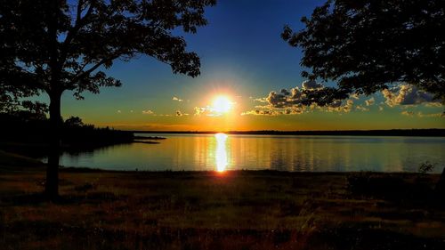 Scenic view of lake against sky during sunset