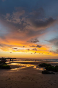 Scenic view of beach against sky during sunset