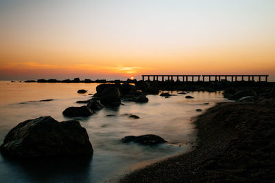 Scenic view of sea against clear sky during sunset