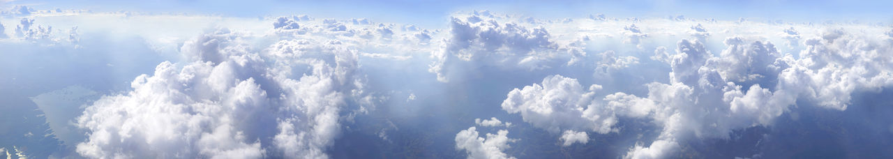 Low angle view of sunlight streaming through clouds