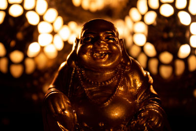 Buddha statue in illuminated temple