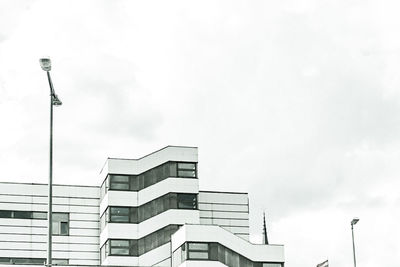 Low angle view of building against cloudy sky