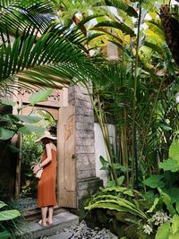 Woman standing by plants