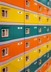 Full frame shot of multi colored yellow and green and orange safety boxes