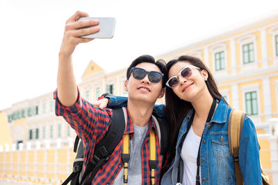 Portrait of young woman using mobile phone