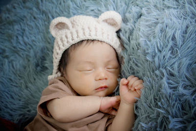 Close-up of baby boy sleeping on bed