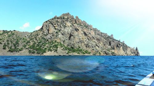 Scenic view of rocks in sea against sky