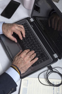 High angle view of man using laptop on table