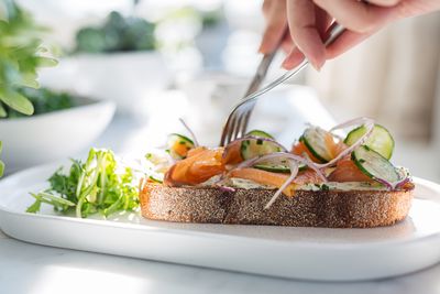 Midsection of man preparing food in plate