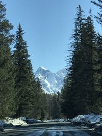 Scenic view of snow mountains against blue sky