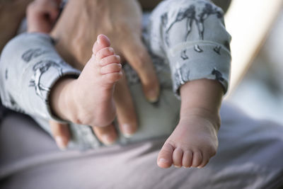 Baby feet in mother hands. tiny newborn baby's feet on female shaped hands closeup. 