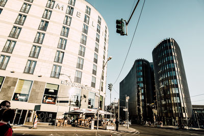 People on street in city against sky