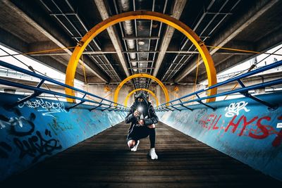 Rear view of man standing on escalator