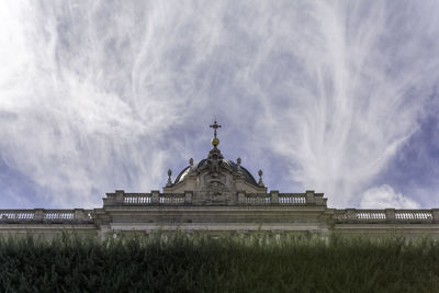 Low angle view of madrid royal palace against cloudy sky