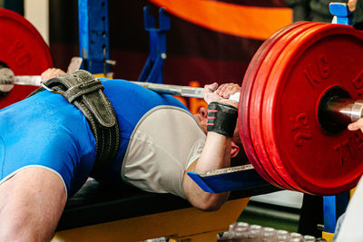 Midsection of man exercising in gym