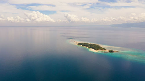 Little liguid island with beautiful beach, palm trees by turquoise water. island, philippines, samal