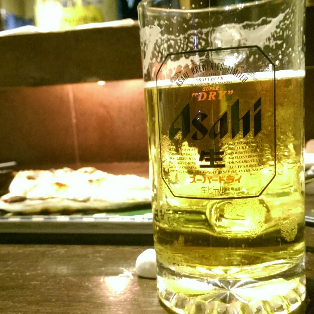 food and drink, drink, indoors, refreshment, freshness, drinking glass, text, glass - material, still life, table, western script, close-up, alcohol, transparent, communication, beer - alcohol, jar, focus on foreground, glass, restaurant