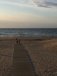 Scenic view of beach against sky during sunset