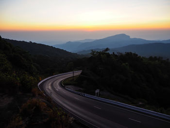 High angle view of road and mountains at sunset