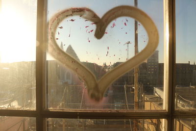 Close-up of heart shape against window