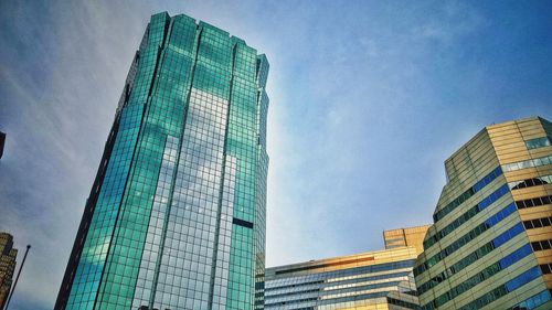 Low angle view of modern building against blue sky