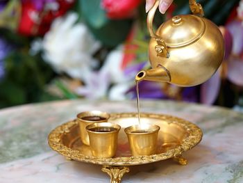 Close-up of tea light candles on table in building