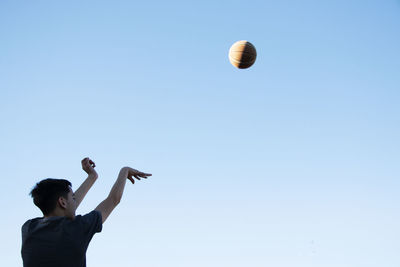 Young basketball player shooting at goal