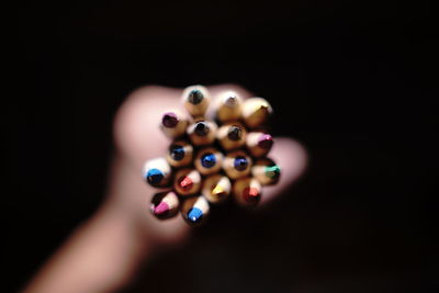Close-up of human hand over black background