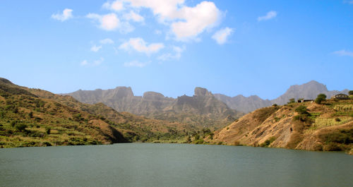 Scenic view of lake and mountains against sky