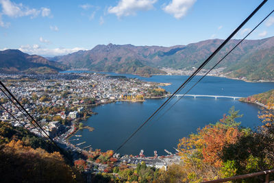 High angle view of trees by mountains against sky