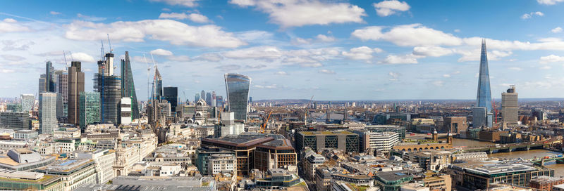 Aerial view of modern buildings in city against sky